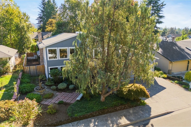 view of front of home featuring driveway and fence