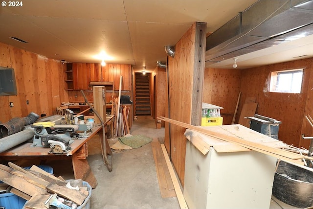 interior space with a workshop area and wood walls