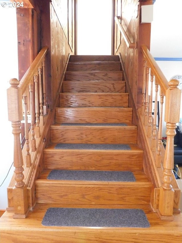 stairway with hardwood / wood-style floors