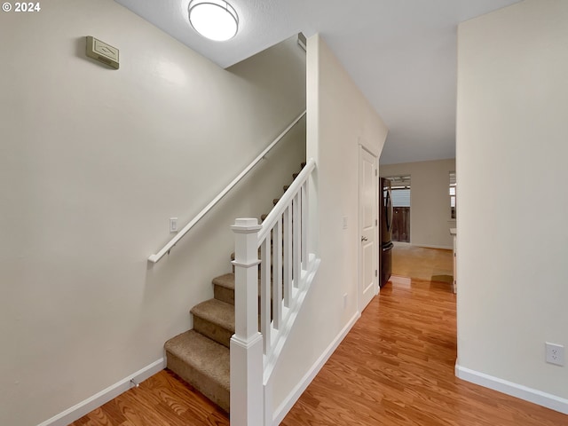 staircase featuring hardwood / wood-style flooring