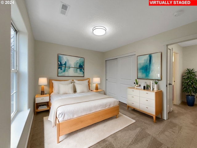 carpeted bedroom with a closet