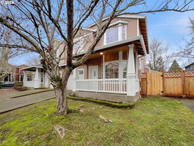 view of front facade with a front yard and a porch