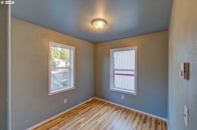 spare room with light hardwood / wood-style floors