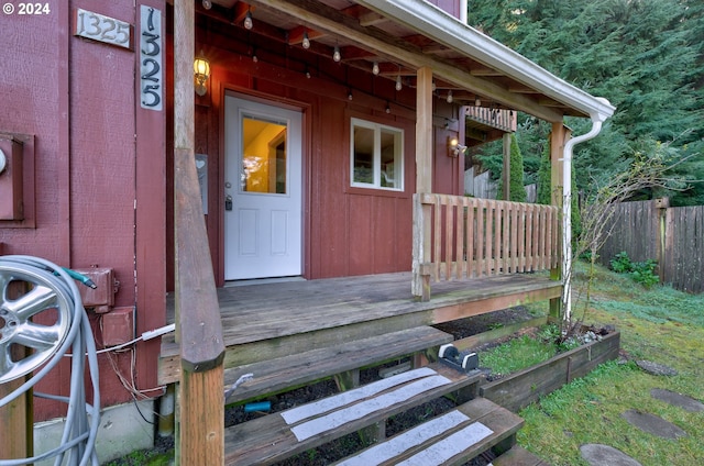 view of exterior entry with a deck