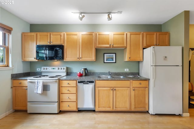 1134 SW Jefferson St Unit 506, Portland, OR 97201 - kitchen with white appliances, dark countertops, a sink, and light wood-style floors