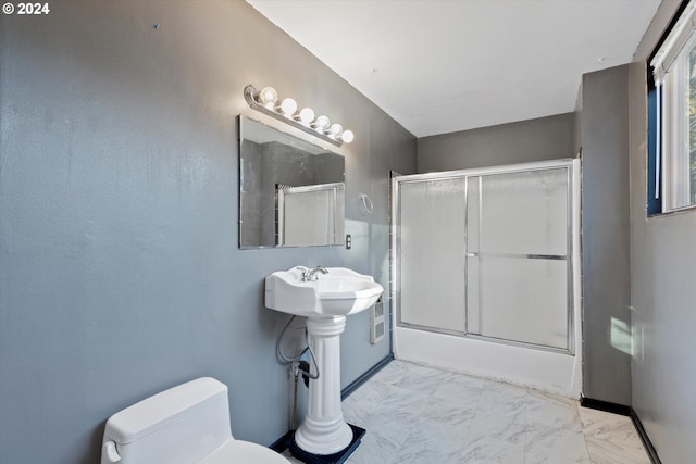 bathroom featuring toilet and enclosed tub / shower combo