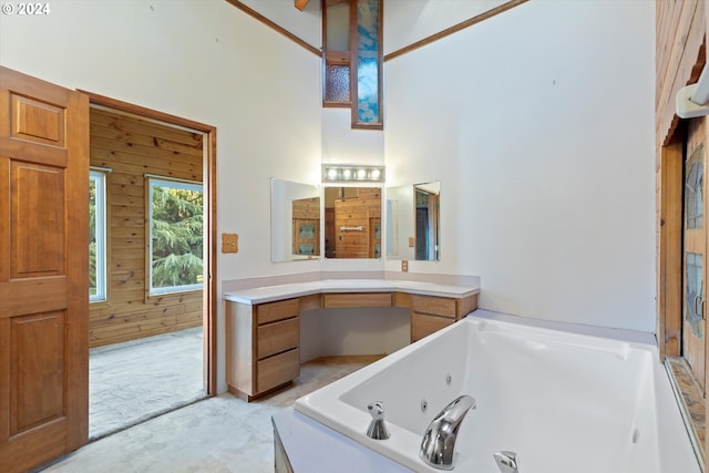 bathroom featuring a washtub, vanity, and wooden walls