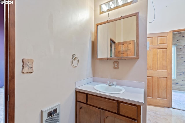 bathroom with vanity and heating unit