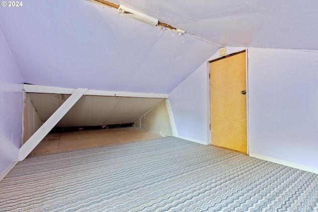 additional living space with carpet flooring and vaulted ceiling