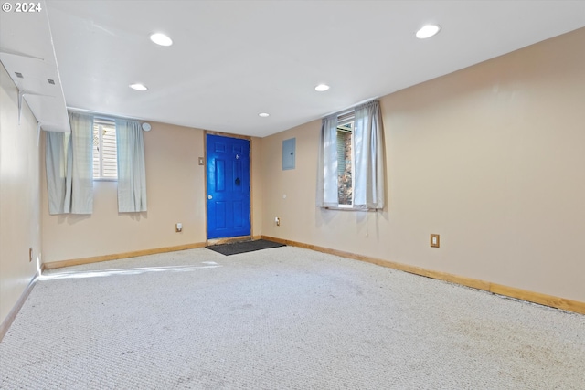 carpeted spare room featuring electric panel