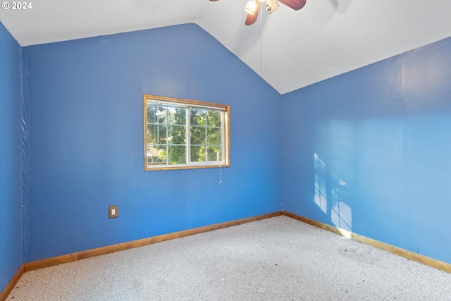 carpeted empty room featuring ceiling fan and vaulted ceiling