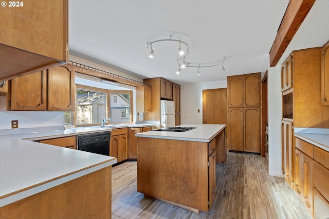 kitchen featuring light wood-type flooring, sink, white refrigerator, dishwasher, and a center island