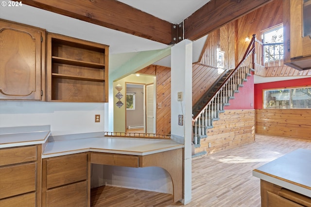 kitchen with wooden walls and light wood-type flooring