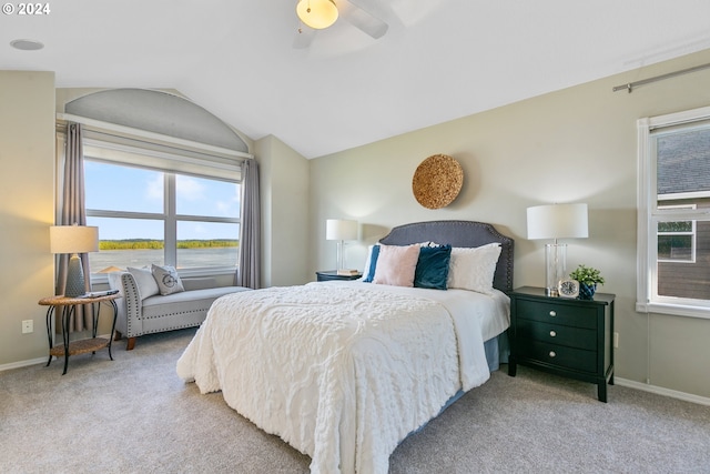 carpeted bedroom with lofted ceiling, baseboards, and a ceiling fan