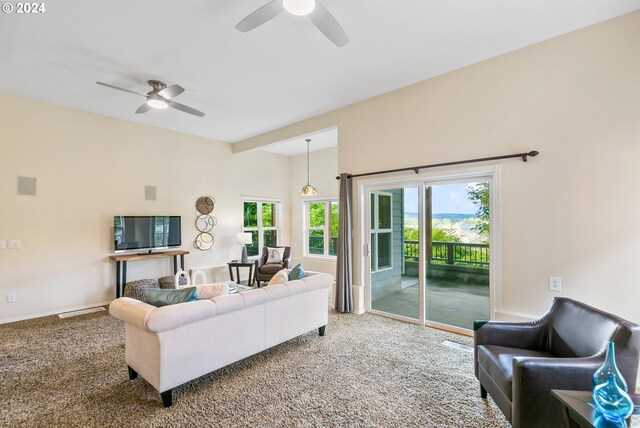 carpeted living room with a ceiling fan, visible vents, and baseboards