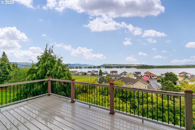 deck featuring a residential view and a water view