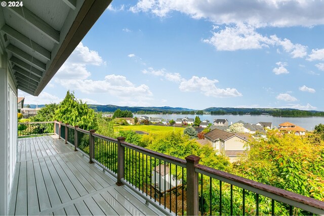 deck with a water and mountain view