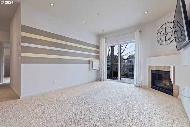 unfurnished living room featuring light carpet and a wall mounted AC