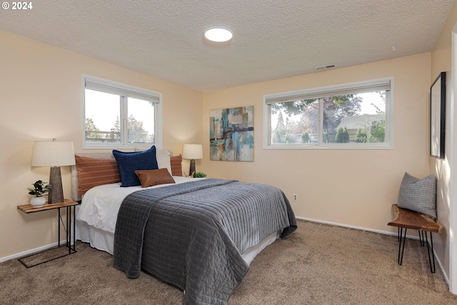 carpeted bedroom with a textured ceiling