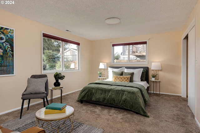 carpeted bedroom featuring a textured ceiling