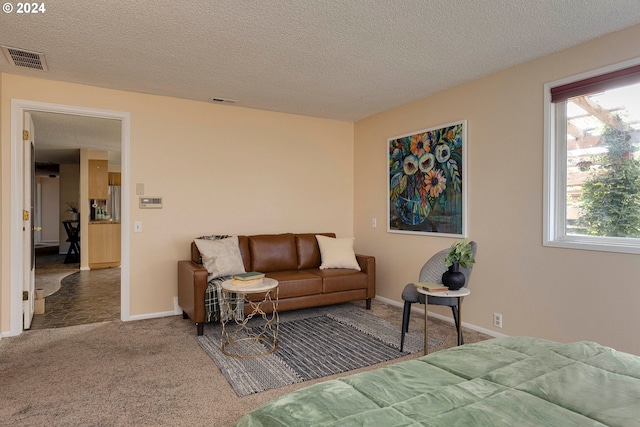 carpeted bedroom featuring a textured ceiling