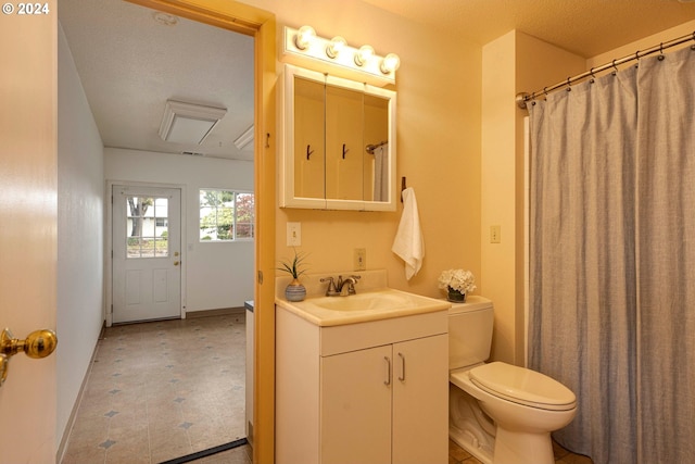 bathroom featuring toilet, vanity, and a textured ceiling