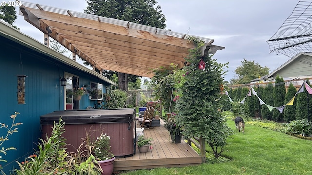 wooden deck featuring a hot tub, a pergola, and a yard