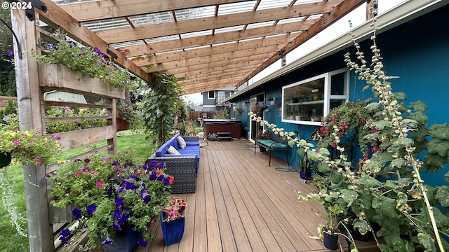 deck featuring a hot tub and a pergola