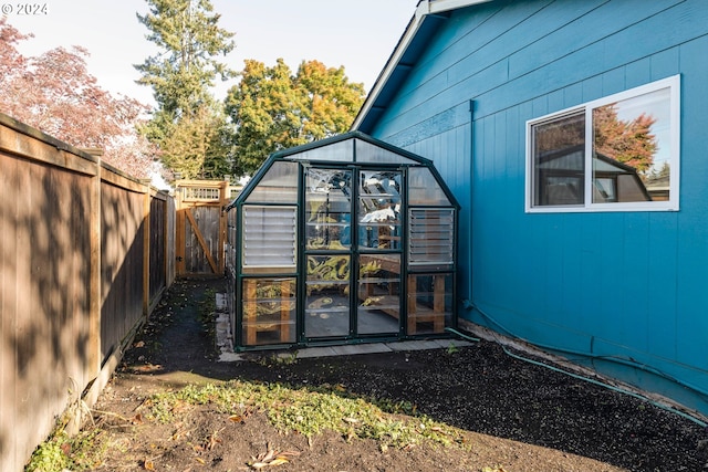 view of side of property with an outbuilding