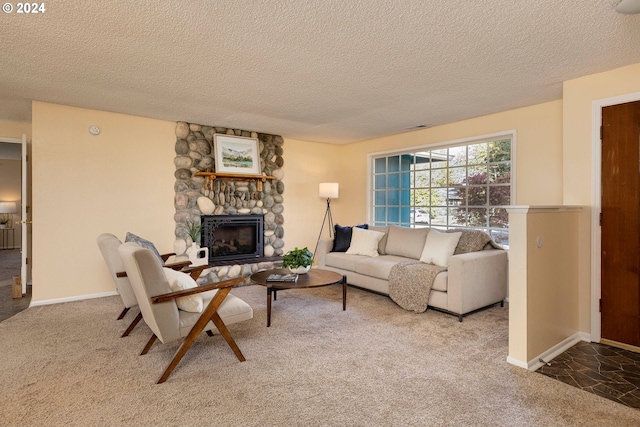 living room with a stone fireplace, a textured ceiling, and carpet floors