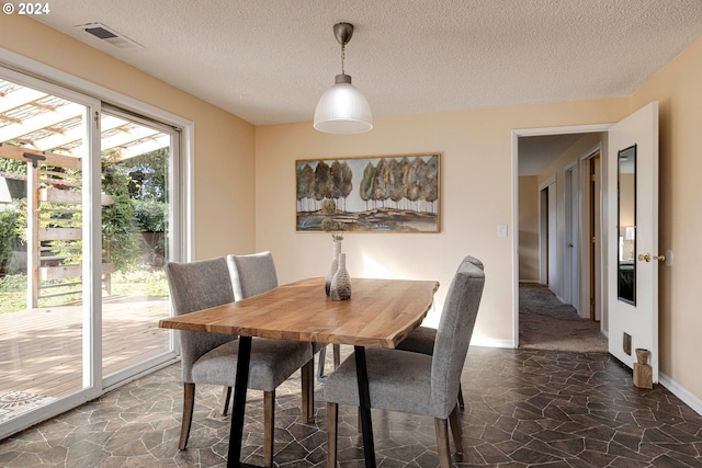 dining space featuring a textured ceiling