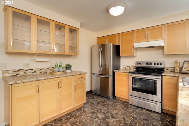 kitchen with stainless steel appliances, light brown cabinets, and light stone counters