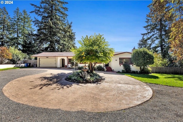 view of front of house featuring a front yard and a garage