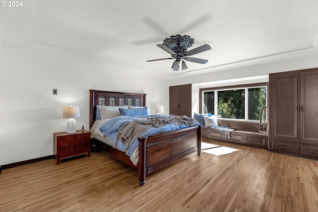 bedroom with light wood-type flooring and ceiling fan