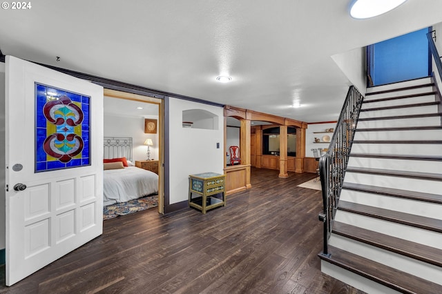 interior space featuring a textured ceiling, ornamental molding, and hardwood / wood-style flooring