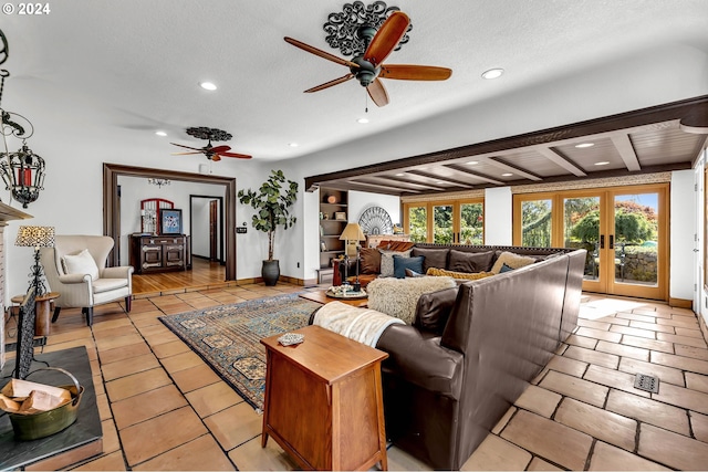 living room featuring a textured ceiling, beam ceiling, ceiling fan, and french doors