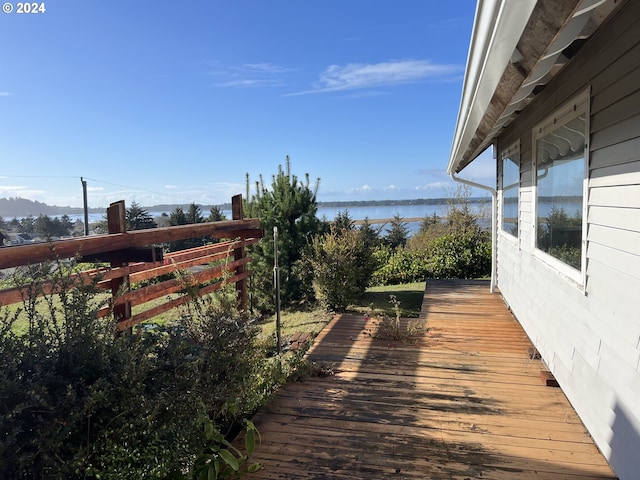 deck with a water and mountain view