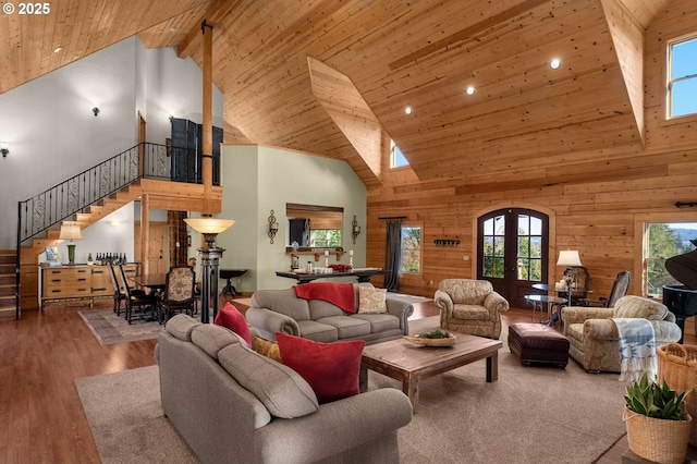 living room featuring high vaulted ceiling, wood ceiling, and french doors