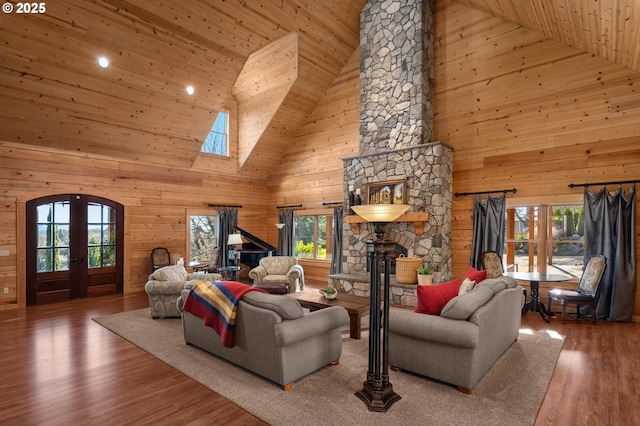 living room featuring wood ceiling, dark wood-type flooring, french doors, wood walls, and high vaulted ceiling