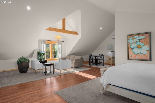 bedroom with hardwood / wood-style floors, a chandelier, and lofted ceiling