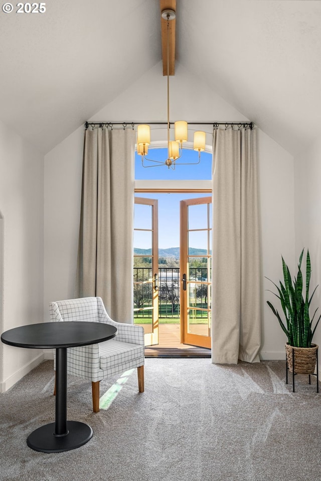 sitting room featuring french doors, lofted ceiling with beams, carpet, a mountain view, and a notable chandelier