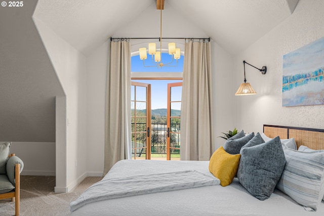 bedroom with a mountain view, lofted ceiling with beams, a notable chandelier, and carpet flooring