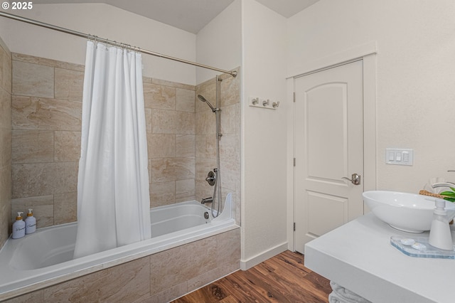 bathroom featuring sink, shower / bath combo with shower curtain, and hardwood / wood-style flooring