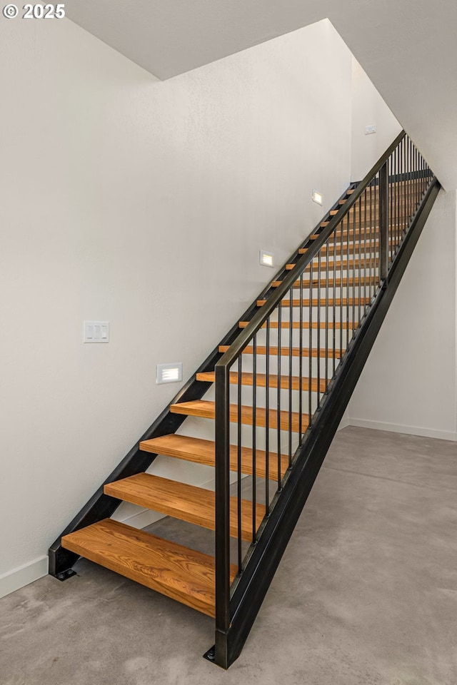 staircase with concrete flooring