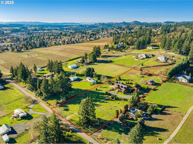 birds eye view of property with a rural view