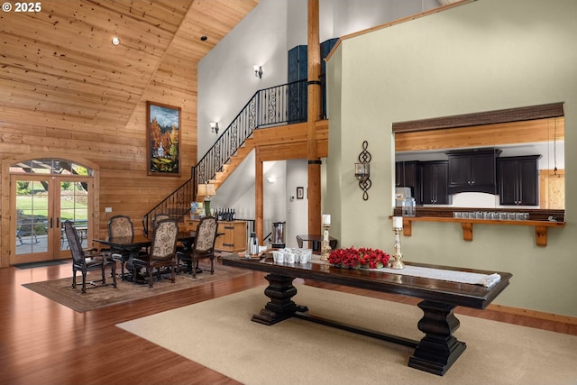 interior space featuring french doors, wood ceiling, hardwood / wood-style floors, high vaulted ceiling, and wooden walls