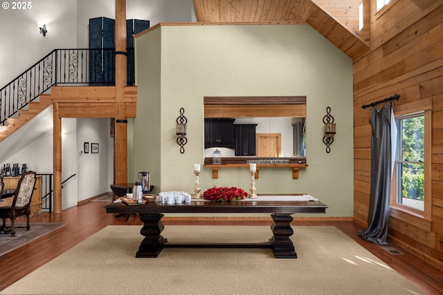 living room featuring high vaulted ceiling, hardwood / wood-style floors, and wood ceiling