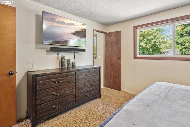 carpeted bedroom with a textured ceiling