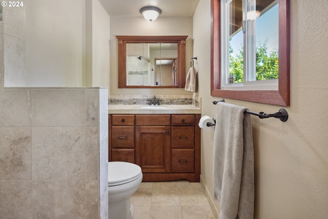 bathroom featuring tile patterned flooring, vanity, and toilet