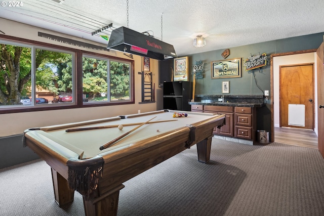 playroom with dark colored carpet, a textured ceiling, and pool table